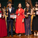 Winners of the Chamber Virtuoso category of the Rave Harps International Prestige Award 2025 stand onstage with their awards