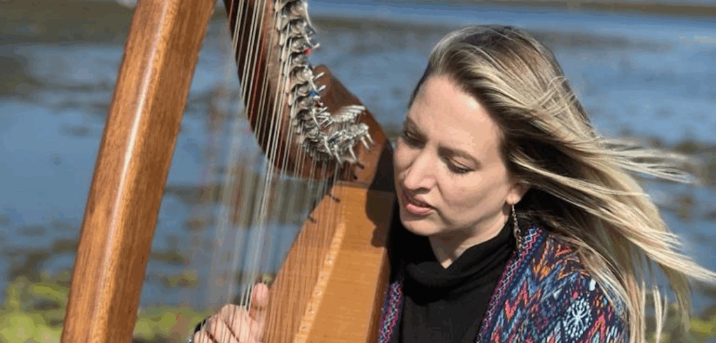 Scottish harpist Ailie Robertson playing her harp at Loch Etive