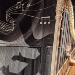 Zoé Buyck performs at the 2022 Martine Géliot competition in front of a backdrop with musical notes