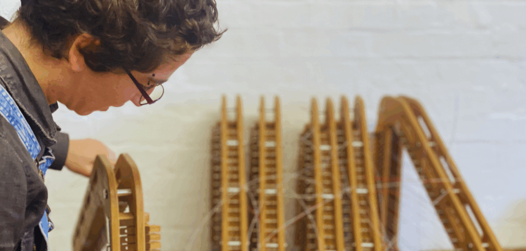 Harp-E London studio manager Sofia Vaisman works to assemble a row of Harp-E harps