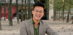 Headshot of Adam Phan smiling, taken outdoors