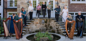 Members of the Cleveland Harp Circle stand outside with four lever harps
