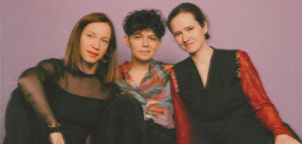 Members of the trio Malvenn pose in a photo edited with a retro filter effect