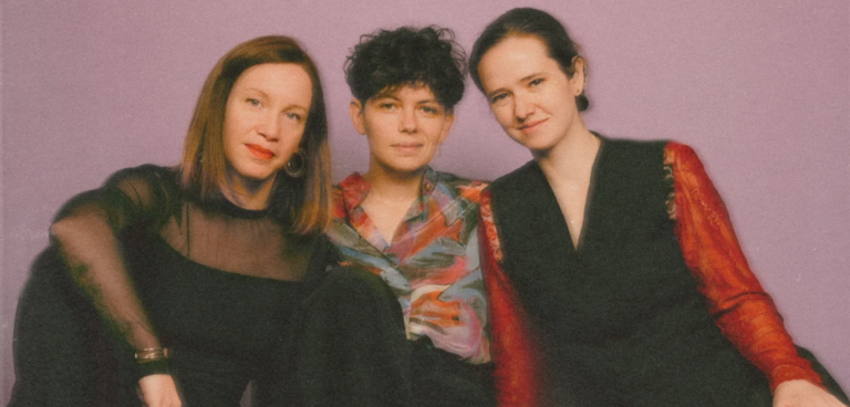 Members of the trio Malvenn pose in a photo edited with a retro filter effect